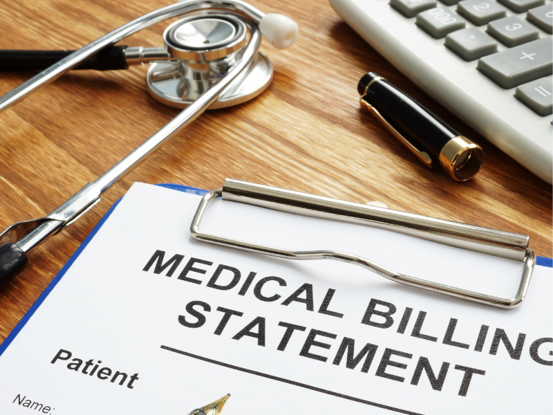 A close-up of a medical billing statement on a clipboard, surrounded by a stethoscope, pen, and keyboard, symbolizing the financial burden of ALS care.