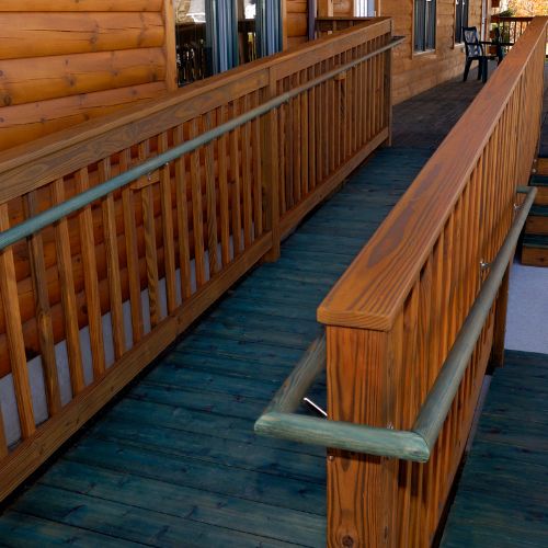 A sturdy wooden wheelchair ramp leading to a home, ensuring accessibility for individuals with ALS.