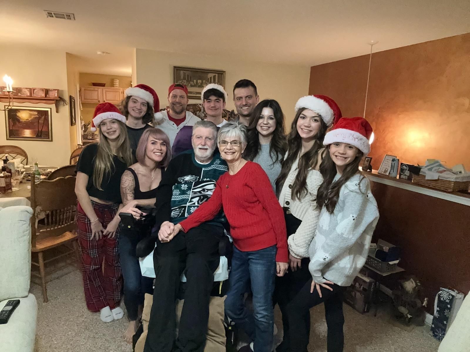 Diane and Bill surrounded by family during Christmas celebration