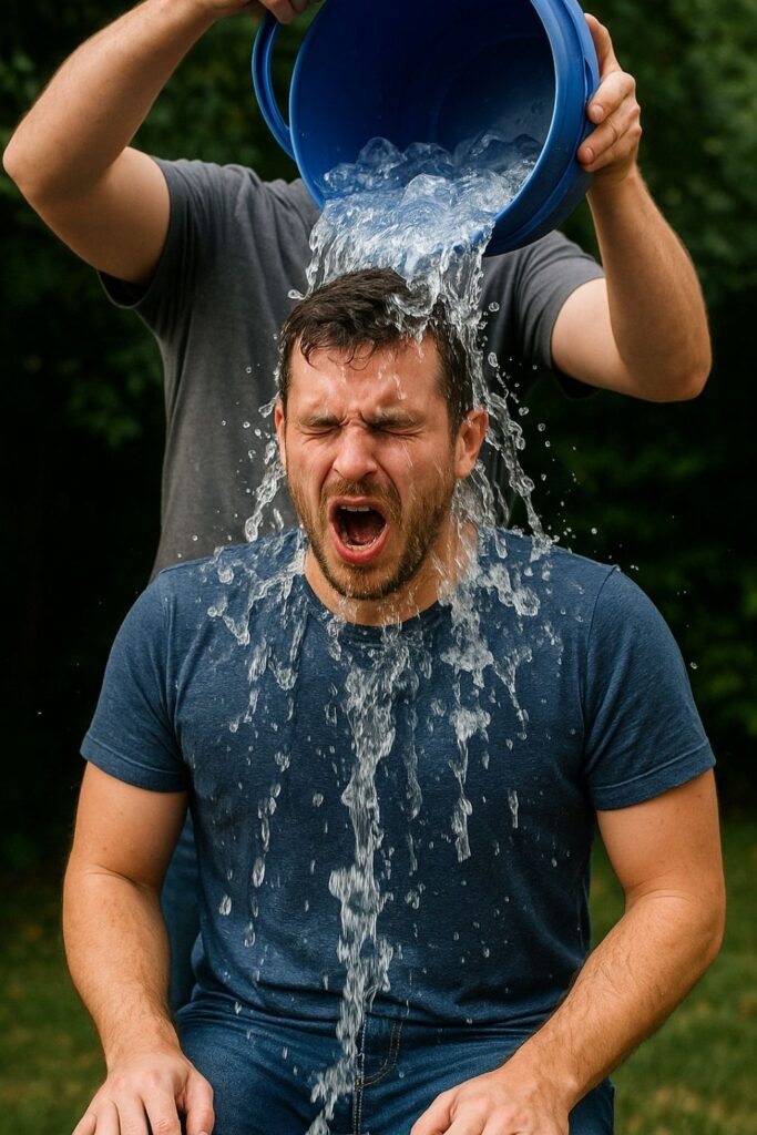 Man participates in ALS Ice Bucket Challenge in a backyard setting, water pouring over his head to raise awareness