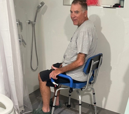 Mike Foster of California using an ALS shower chair provided by Let Hope Grow