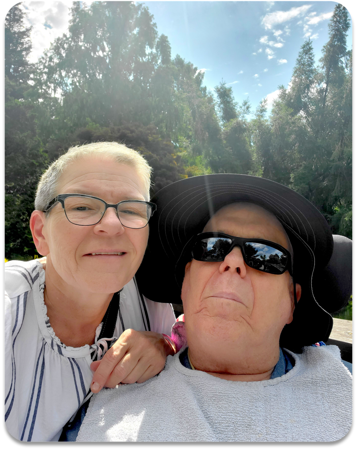 Let Hope Grow ALS family member with caregiver outside with beautiful blue skies.