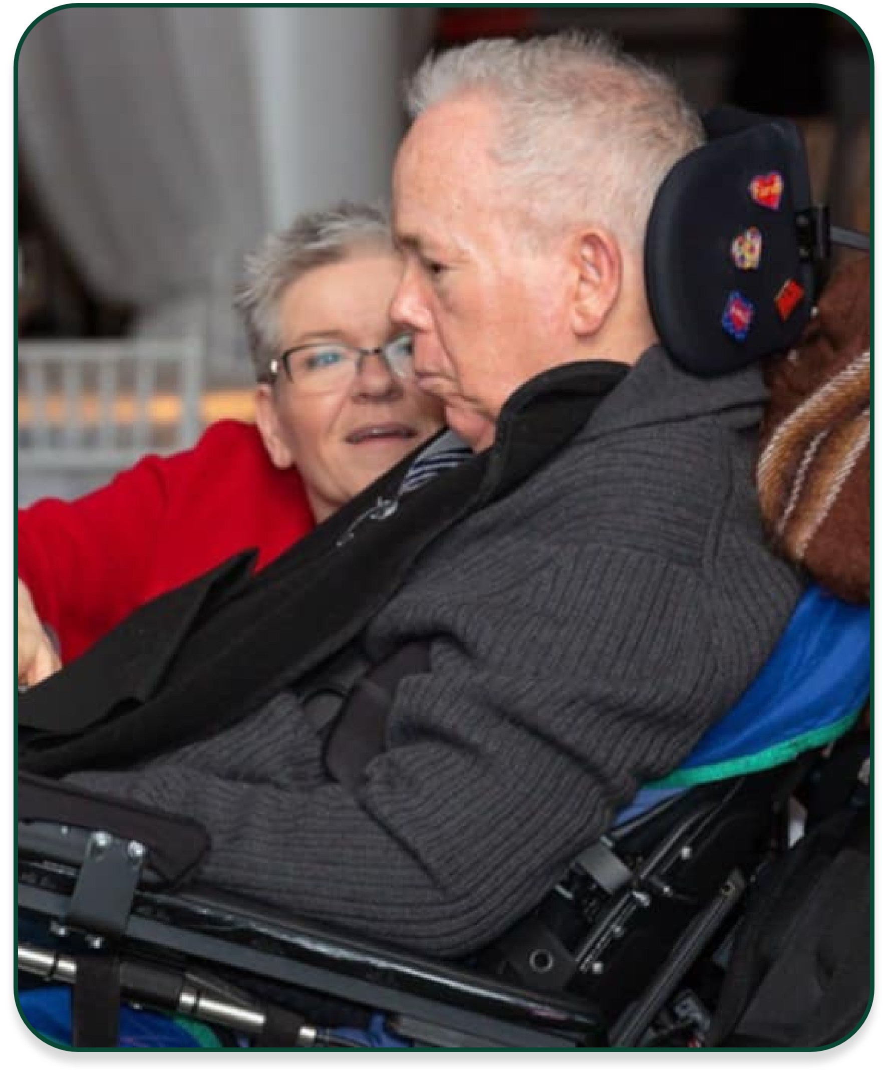 Let Hope Grow family member with ALS in wheelchair and their caregiver next to them