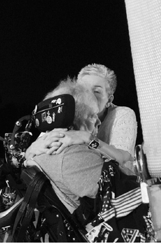Wife giving ALS husband a kiss